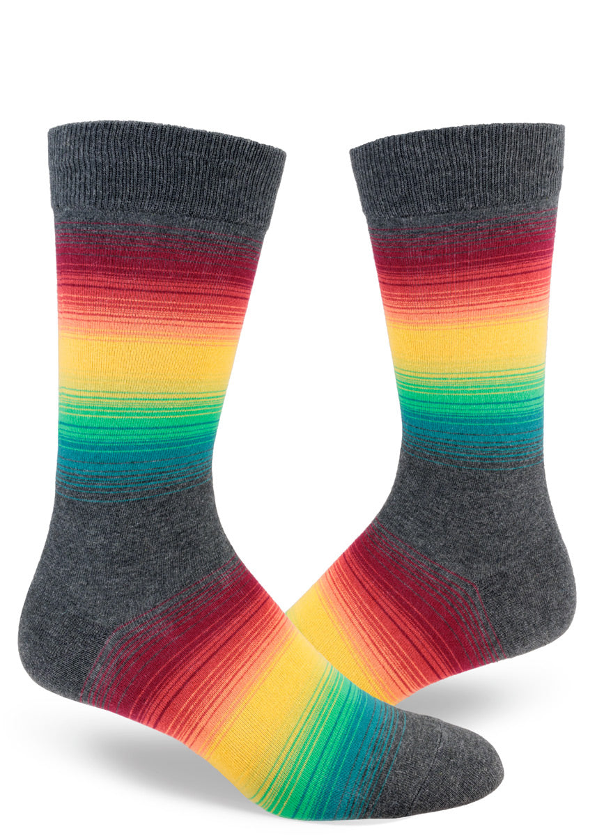 Crew socks for men with thin rainbow stripes set against a charcoal gray background.