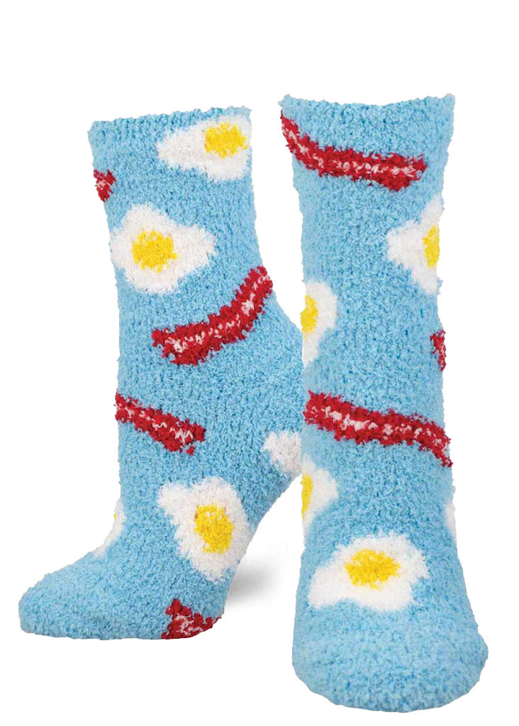 Blue fuzzy socks for women with an allover pattern of bacon and fried eggs.