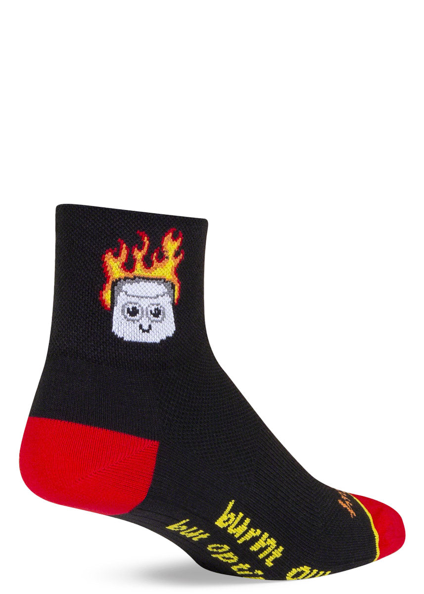 Black athletic ankle socks with a design of a cartoon marshmallow on fire and the words &quot;burnt out but optimistic&quot; written on the bottom of the foot.