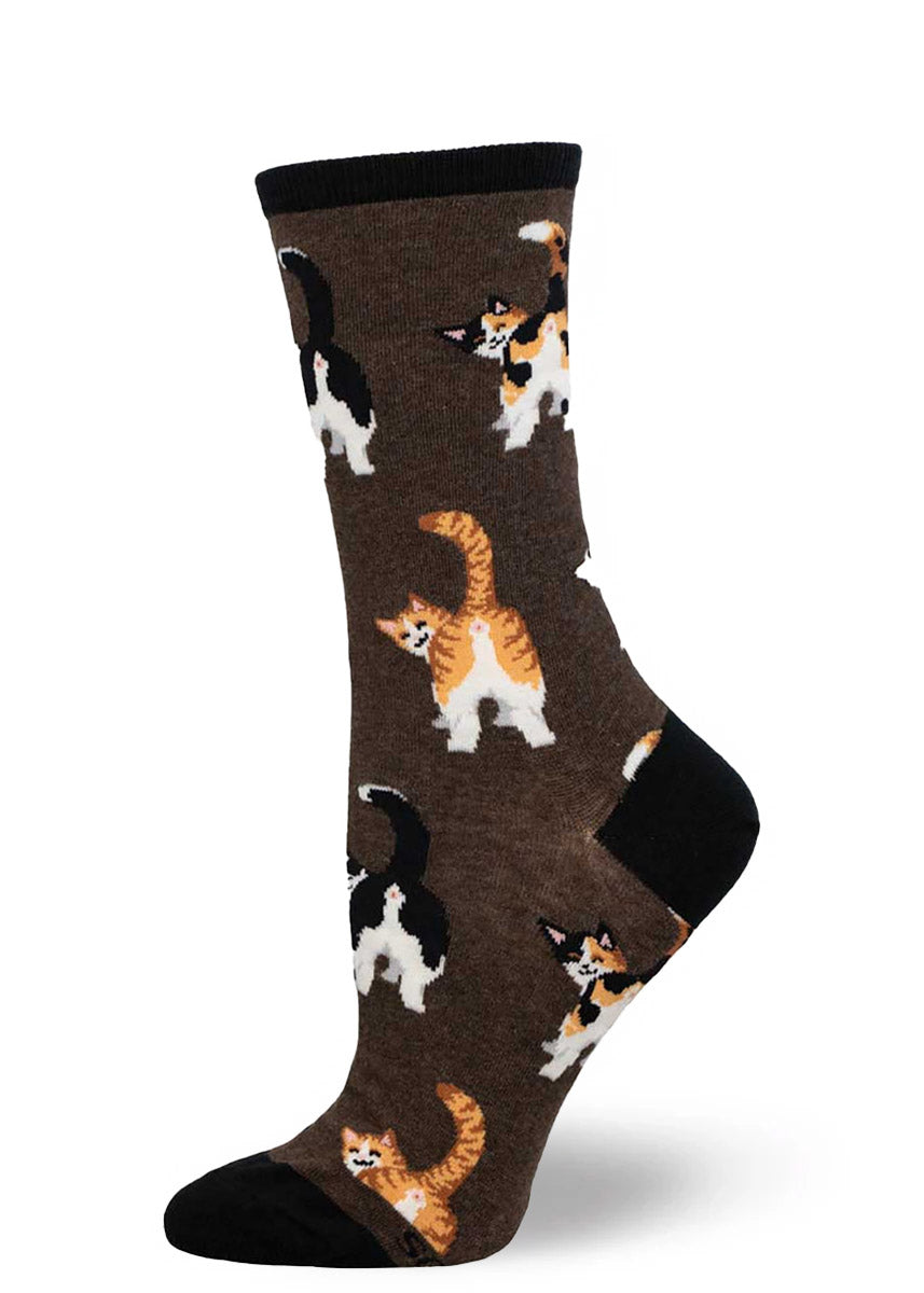 Brown crew socks for women with an allover pattern of different kinds of cats such as orange tabbies and calicos posing with their behind showing.