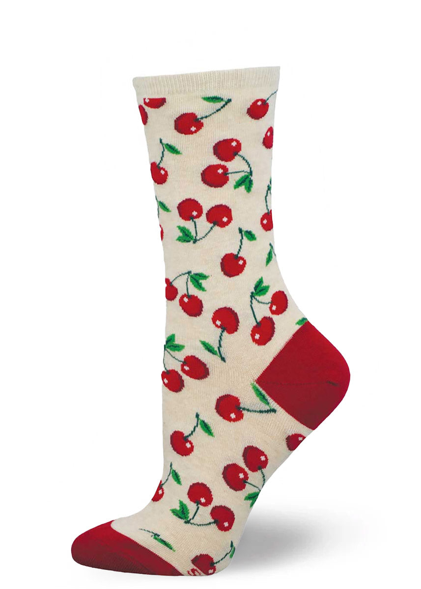 Cream crew socks for women with an allover pattern of red cherries.