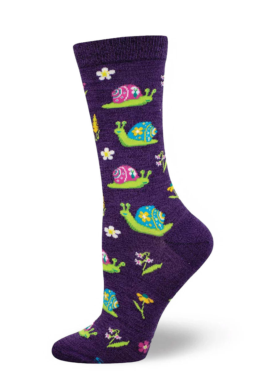 Purple crew socks for women with an allover pattern of colorful snails and flowers.