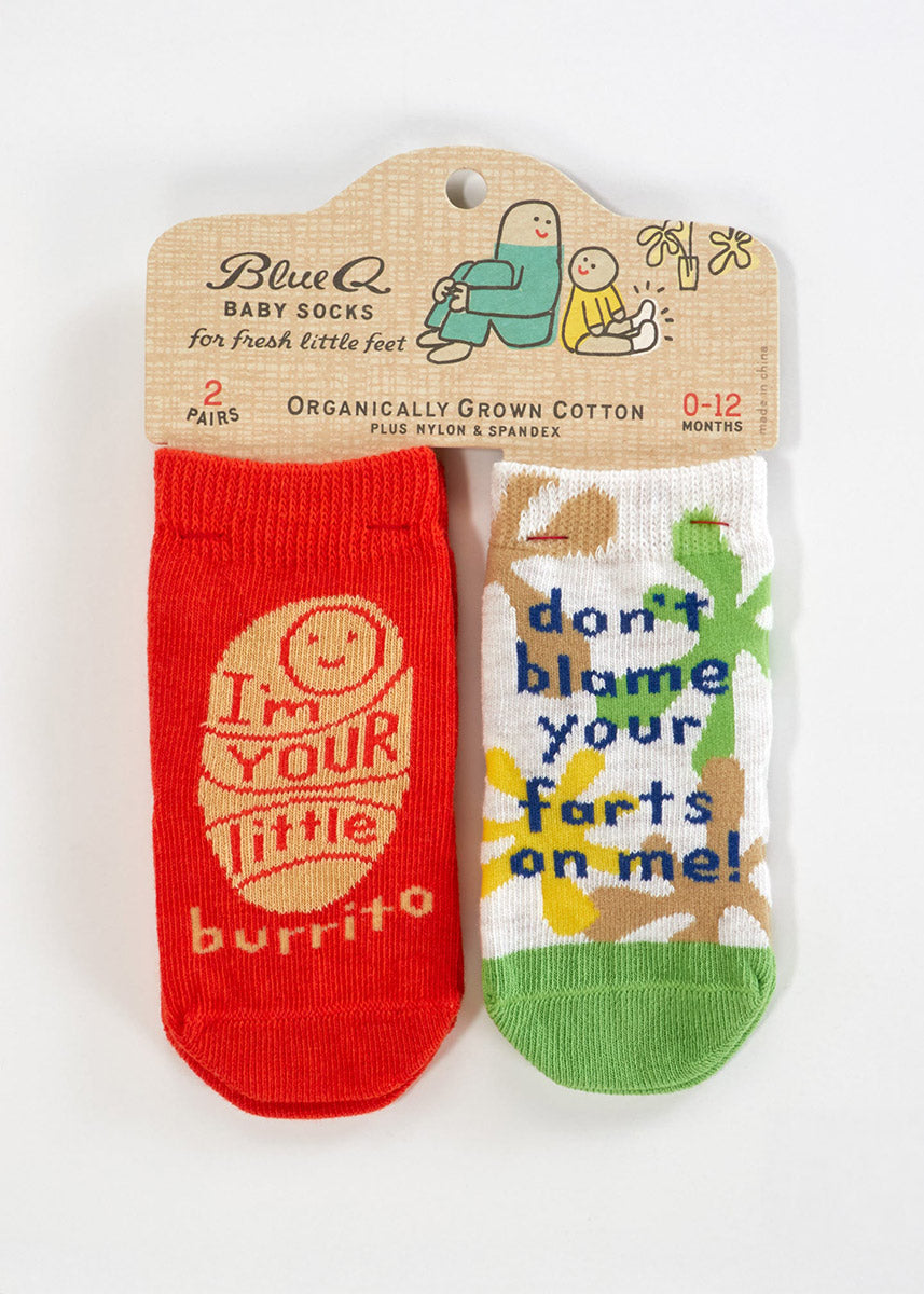 Two pairs of socks for babies: one pair features a cartoon baby swaddled against an orange background with the words &quot;I&#39;m Your Little Burrito&quot; and the other has a green, brown, and yellow organic pattern with the words &quot;Don&#39;t Blame Your Farts On Me!&quot;