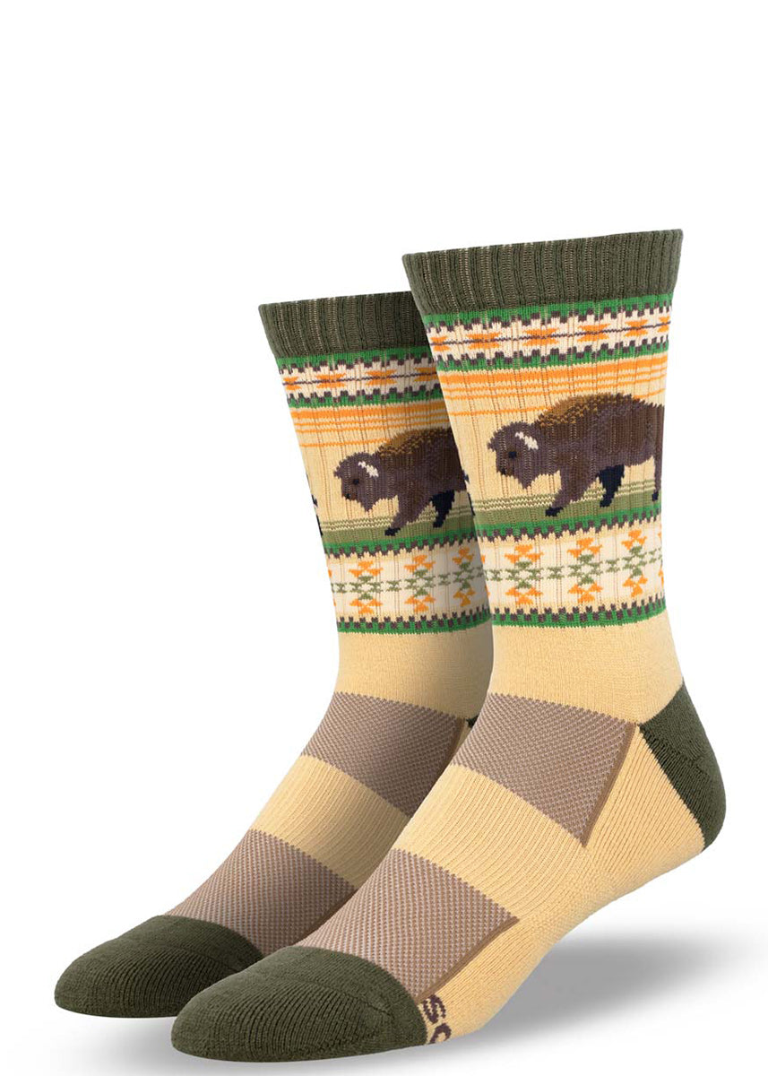 Cream hiking socks for men show a brown buffalo and a green and orange southwestern-style pattern.