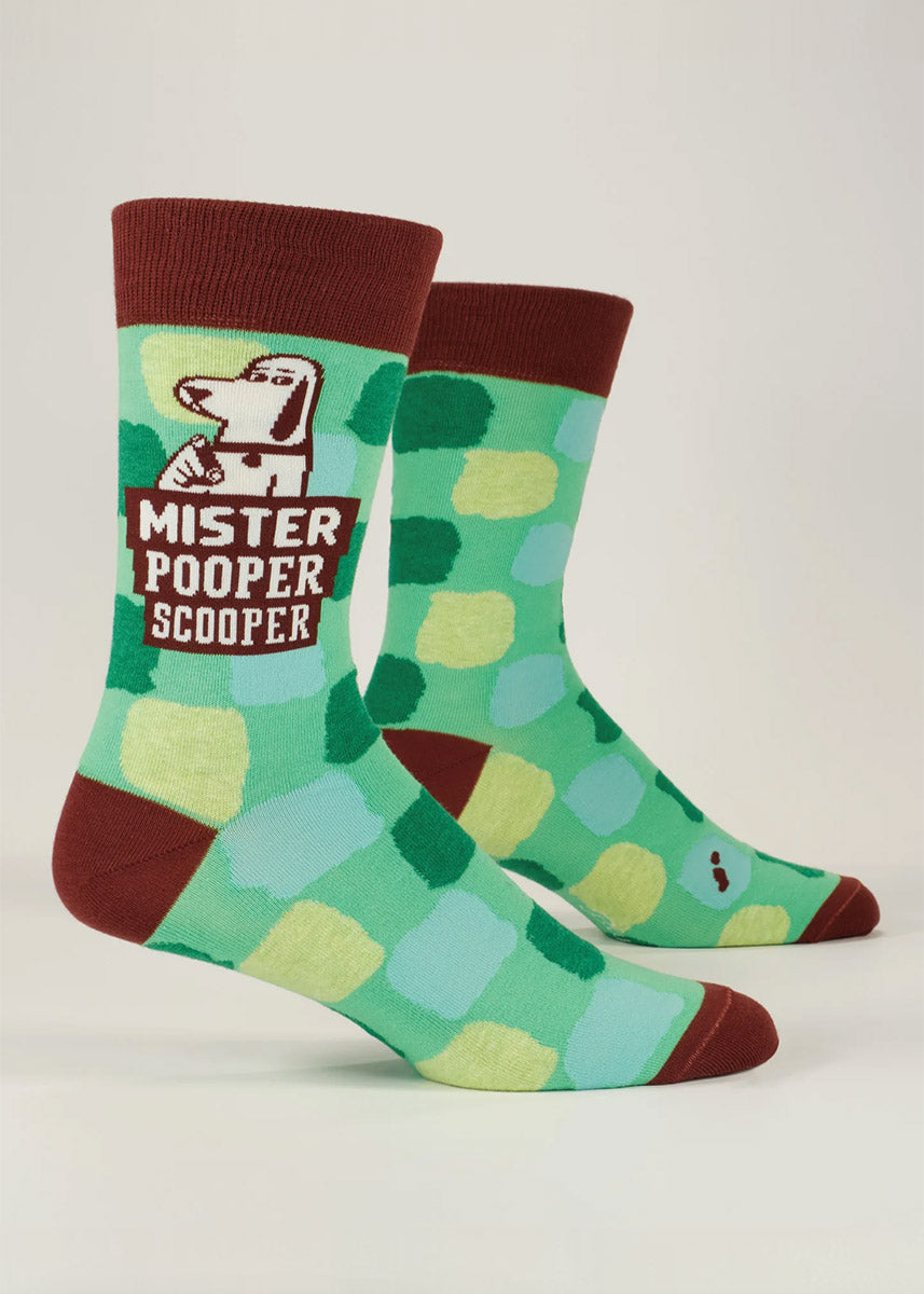 Green novelty crew socks for men  featuring a cartoon dog along with the words "Mister Pooper Scooper" against a geometric background.