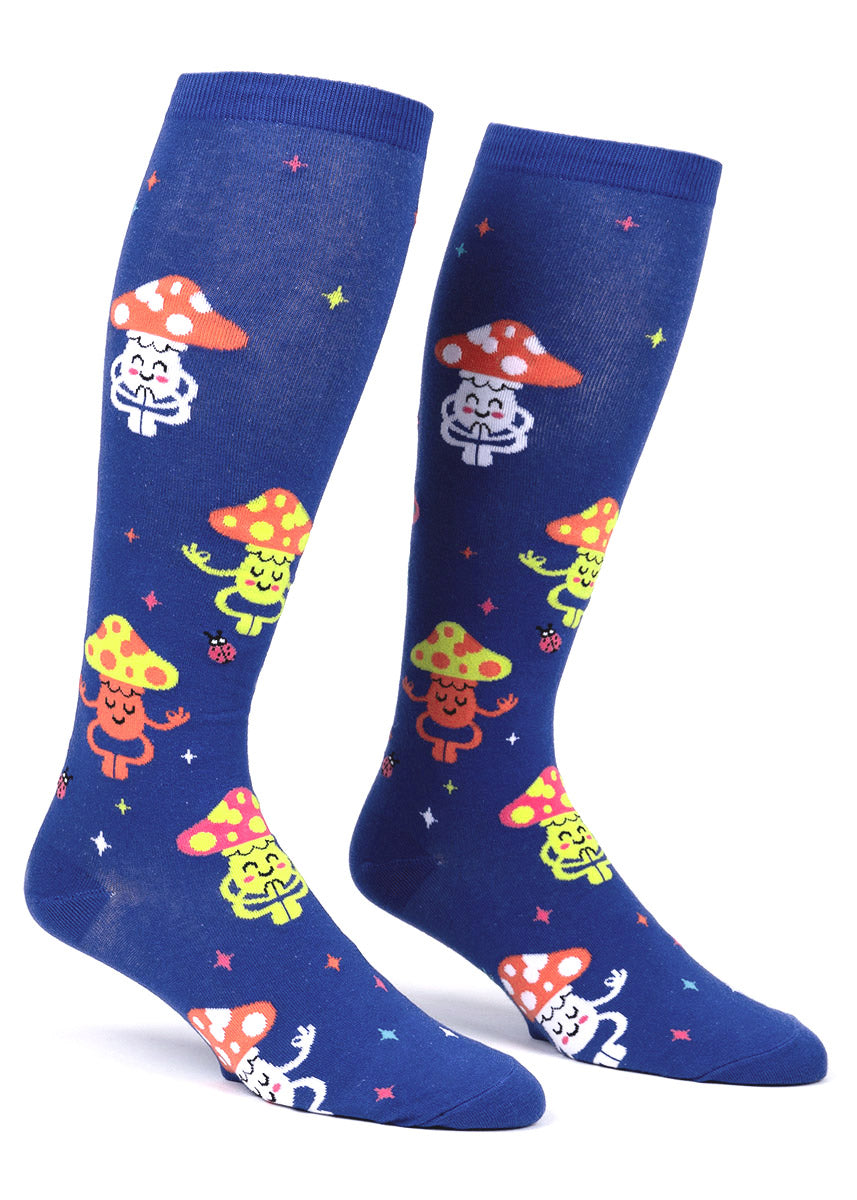 Blue knee-high socks for wide calves with an allover pattern of colorful smiling toadstool mushrooms with arms and legs posing like they&#39;re meditating as well as stars and ladybugs.