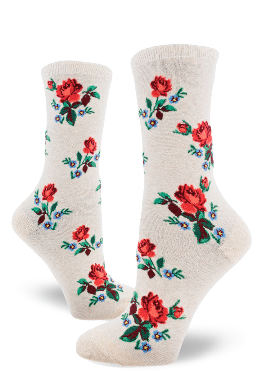 Cream crew socks for women with red roses and blue floral accents in an allover pattern.