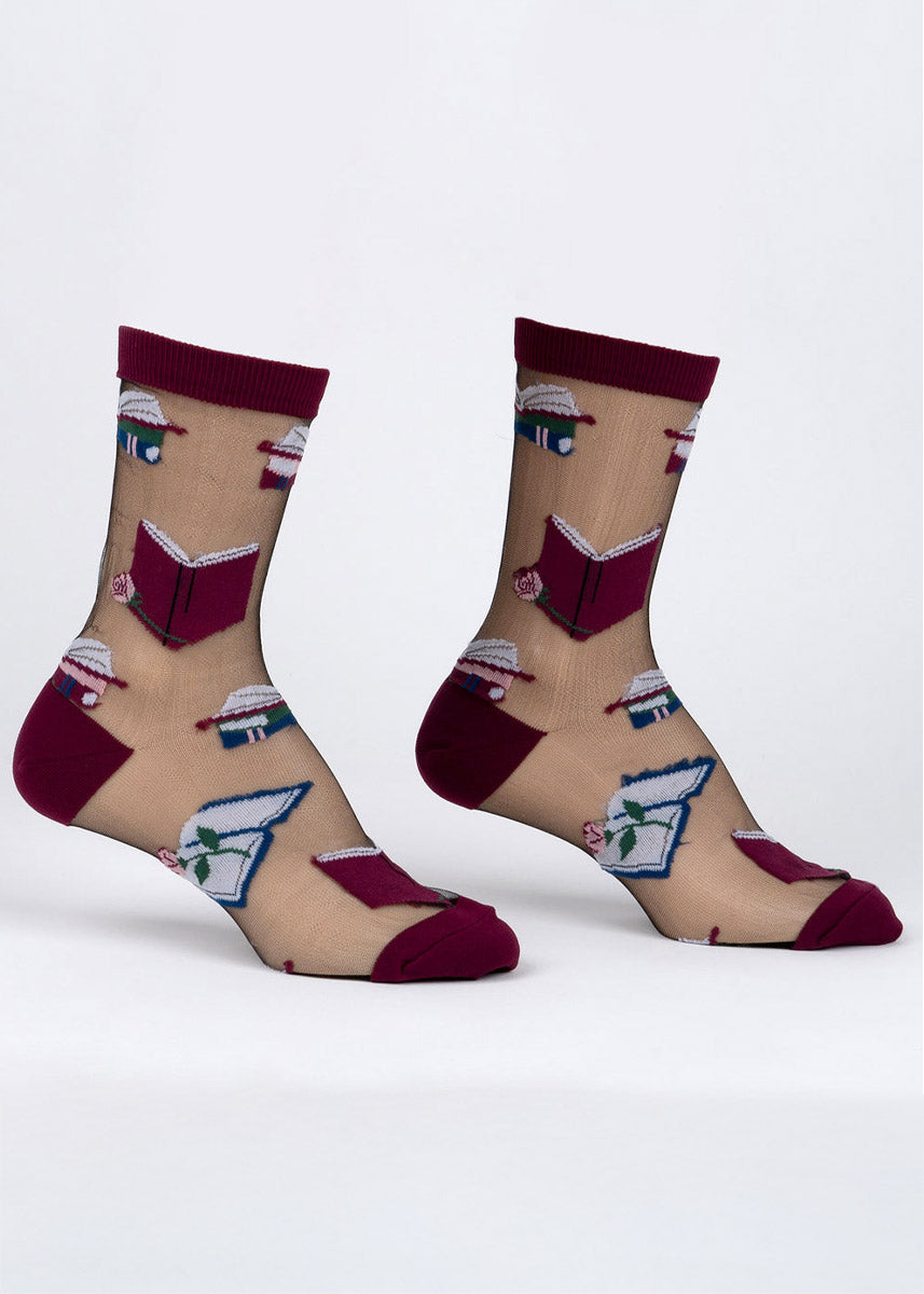 Sheer black crew socks for women with a dark red cuff, heel and toe and an allover pattern of books and roses.