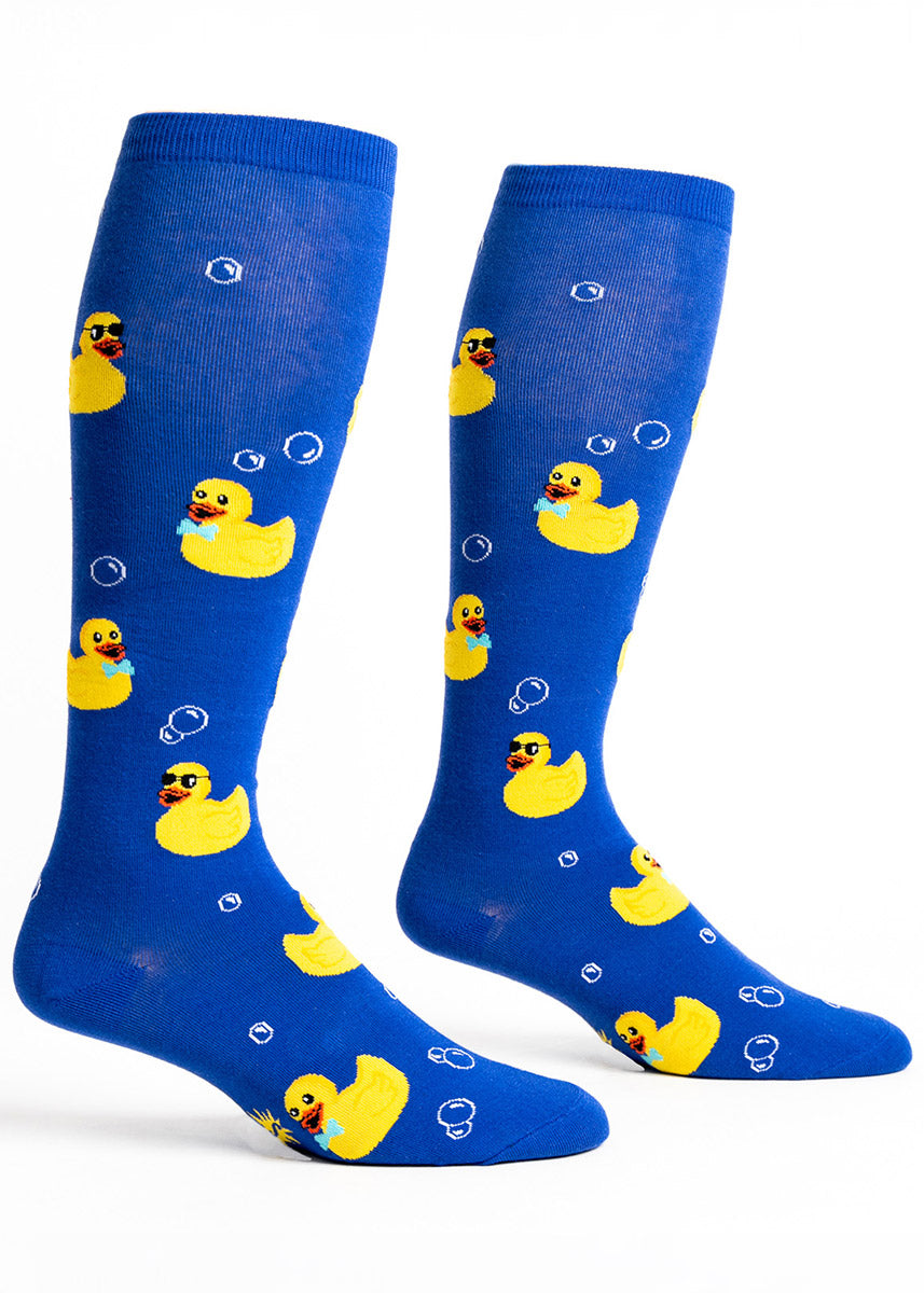 Blue knee-high socks for wide calves with a pattern of bubbles and yellow rubber ducks wearing bow ties and sunglasses. 