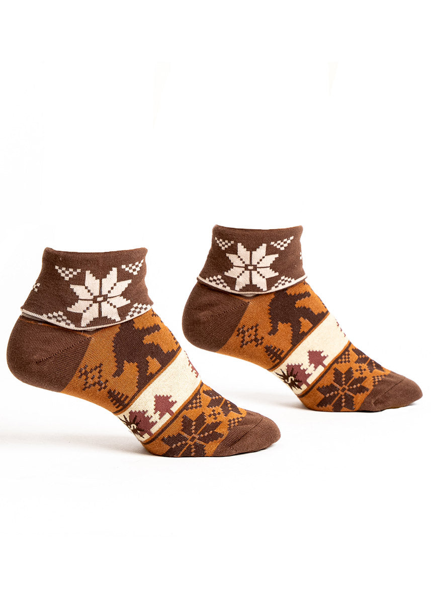 Brown turn-cuff ankle socks for women with an ugly sweater pattern in shades of brown that features a Sasquatch and pine trees. 