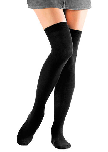 A female model poses wearing solid black over-the-knee socks.