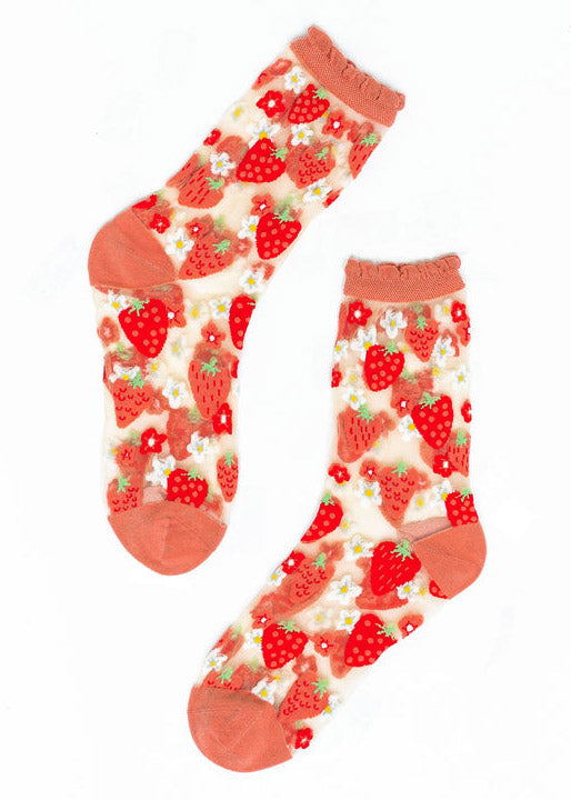 Sheer crew socks for women with an allover pattern of strawberries and daisies against sheer white fabric with a pink ruffle cuff. 
