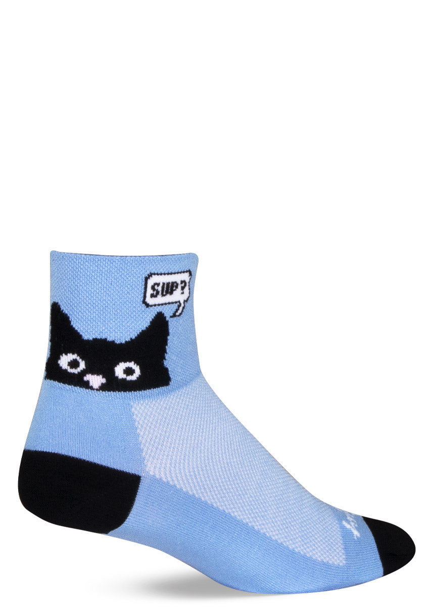 Light blue athletic ankle socks with a black cat face peeking up on the cuff with a speech bubble that says, &quot;Sup?&quot; 