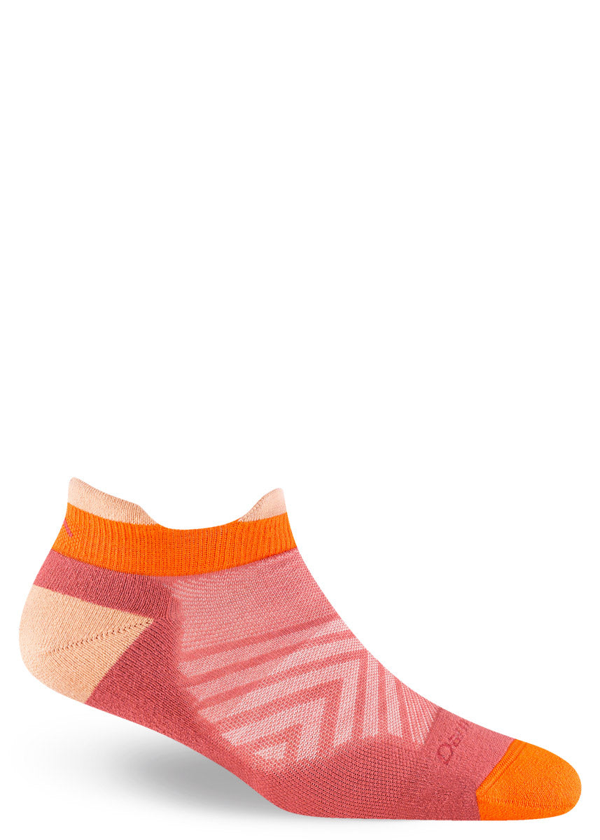 Running socks for women in salmon pink with peach and orange accents in a low-cut ankle profile with tabs at the front and back.