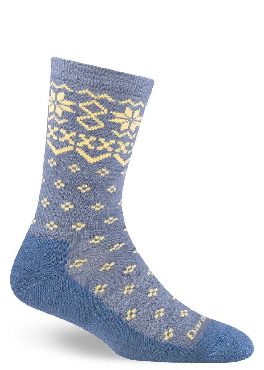 Blue wool crew socks for women with cream snowflake designs throughout inspired by the knitting patterns of the Scottish Isles.