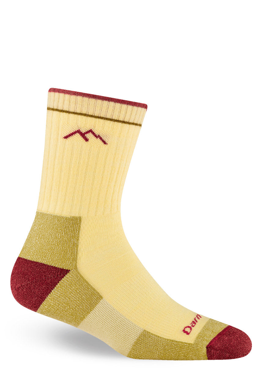 Yellow wool hiking socks for women in crew length, with gold and red accents on the foot.