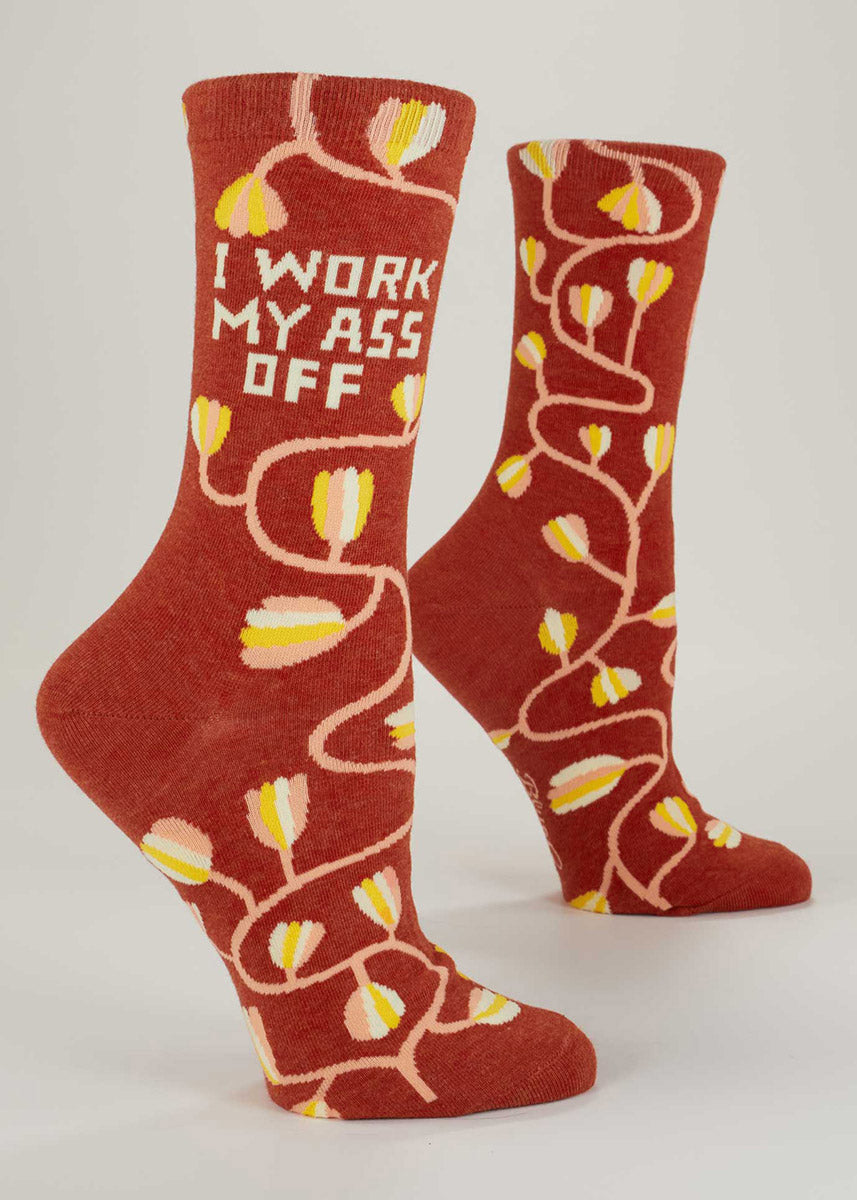 Burnt orange crew socks for women with a yellow, peach, and white floral design and the words, &quot;I work my ass off.&quot;